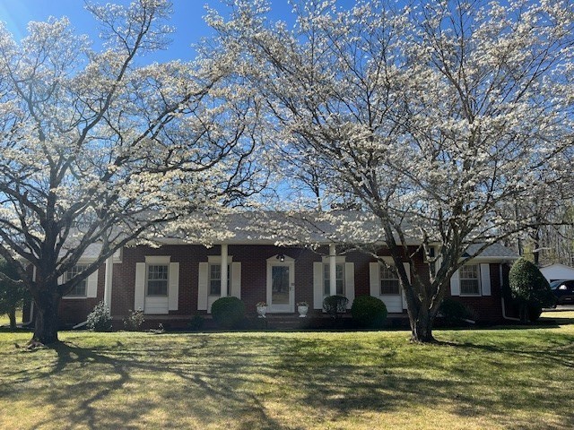 1386 Chisholm Road Cypress Inn, TN 38452 - Photo 2 of 58 a front view of a house with a yard