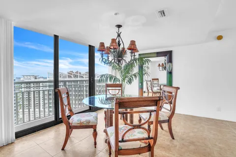 a dining room with furniture a chandelier and wooden floor