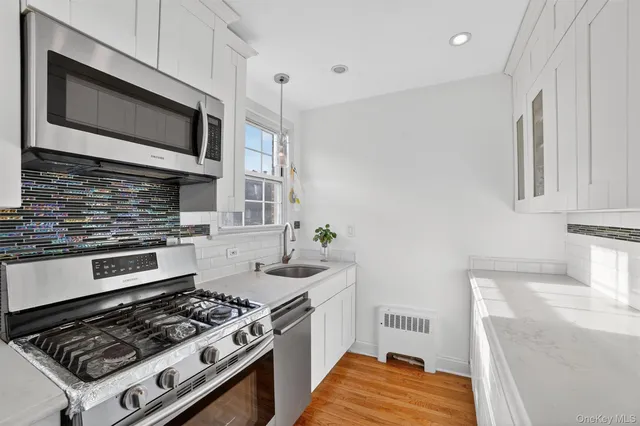 a kitchen with stainless steel appliances granite countertop a stove and a microwave