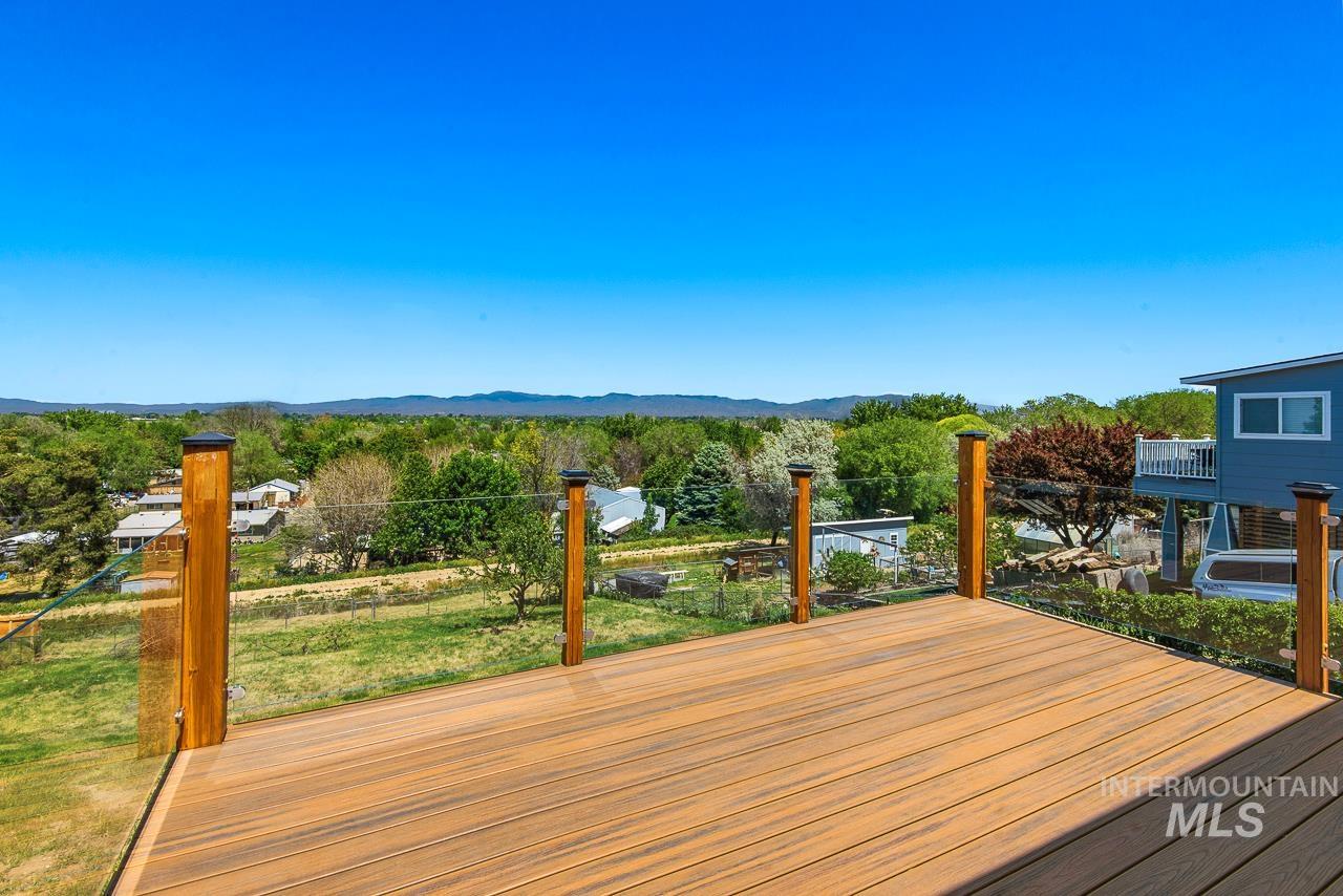10178 West Fox Ridge Drive Boise, ID 83709 - Photo 7 of 36 Spacious outdoor deck featuring wood-finish flooring and clear panel railings