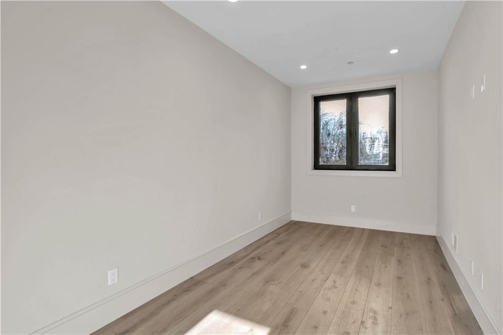 266 10th Street, Unit 2 Brooklyn, NY 11215 - Photo 8 of 17 an empty room with wooden floor and windows
