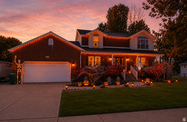 5727 South 3550th Street West Roy, UT 84067 - Photo 5 of 49 Two-story brick-front residence with a two-car garage and a concrete driveway
