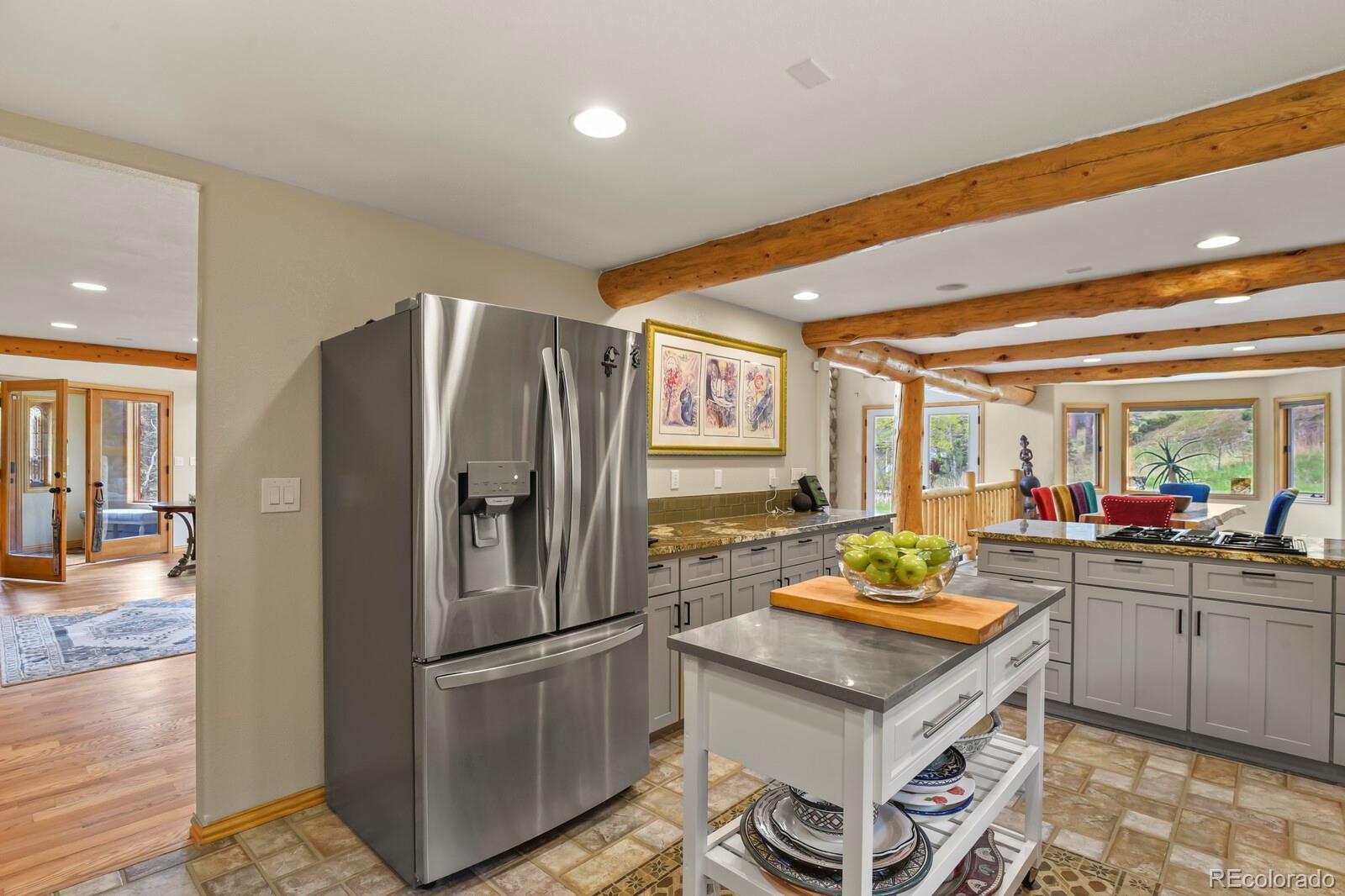 417 Witter Gulch Road Evergreen, CO 80439 - Photo 17 of 50 a kitchen with refrigerator and cabinets
