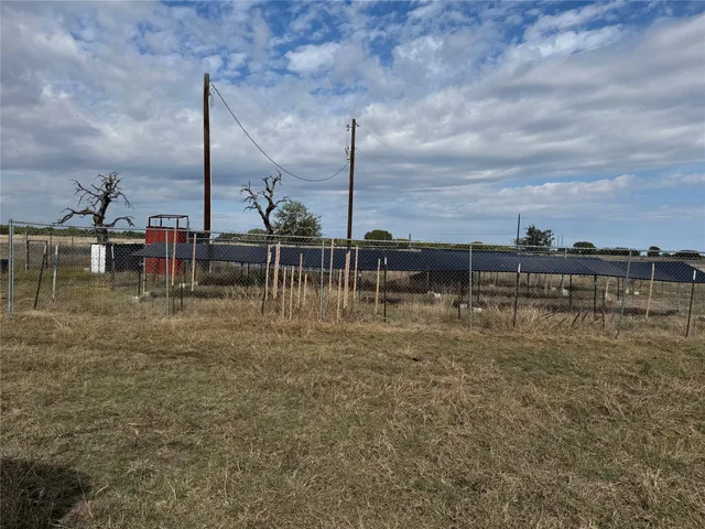 a view of a lake with a big yard and palm trees