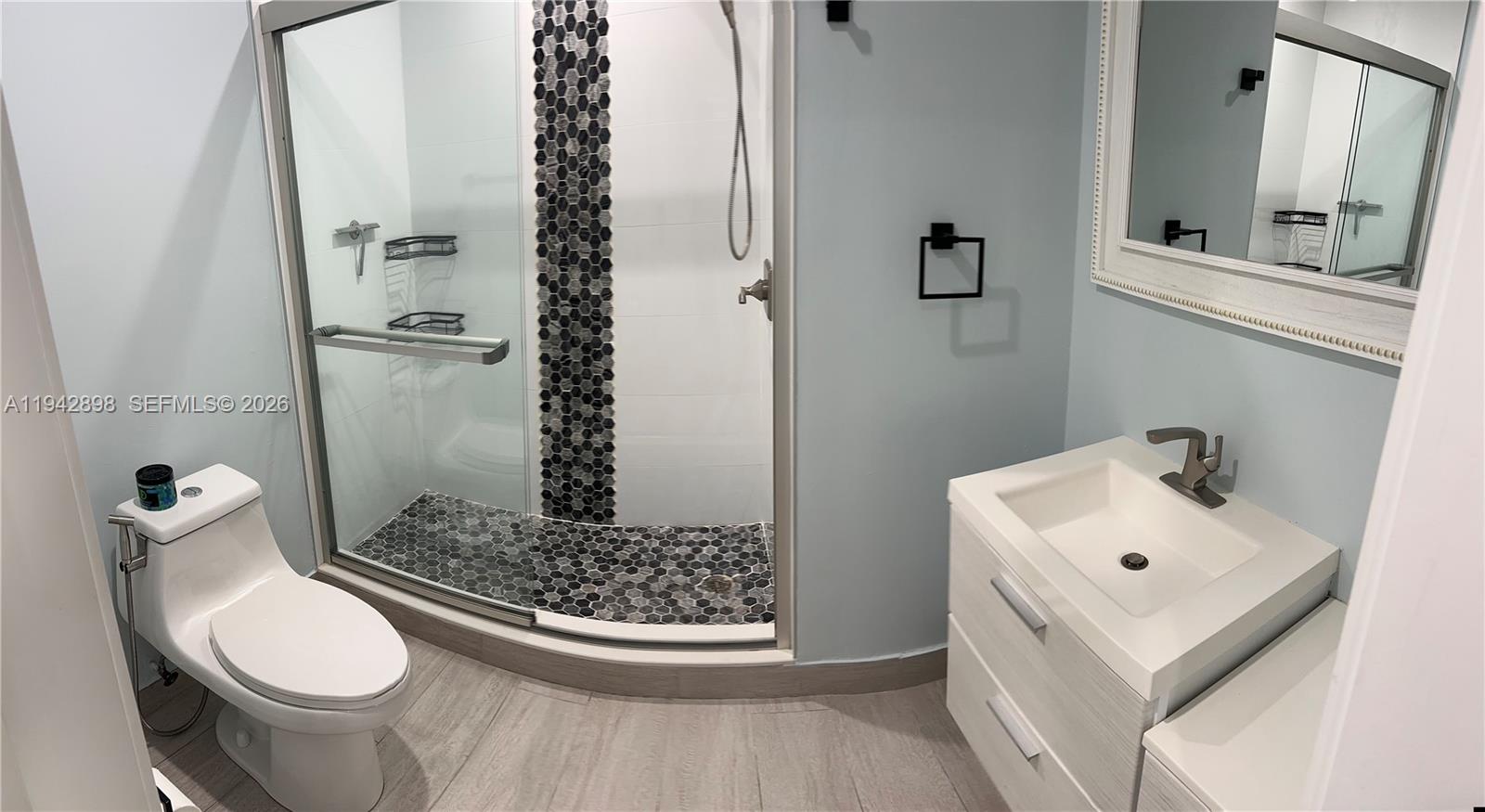 15250 Southwest 134th Place, Unit 112 Miami, FL 33177 - Photo 12 of 17 a bathroom with a sink toilet and shower