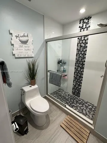a bathroom with a toilet a sink and a mirror