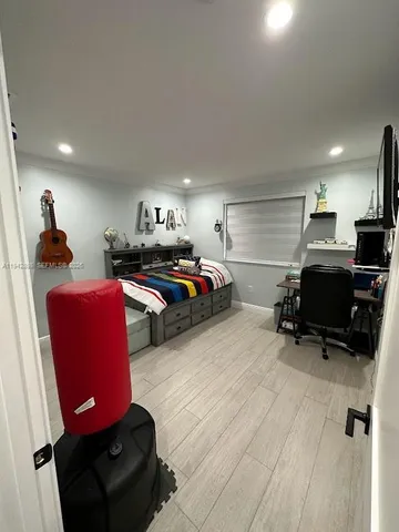 a bedroom with furniture and a wooden floor