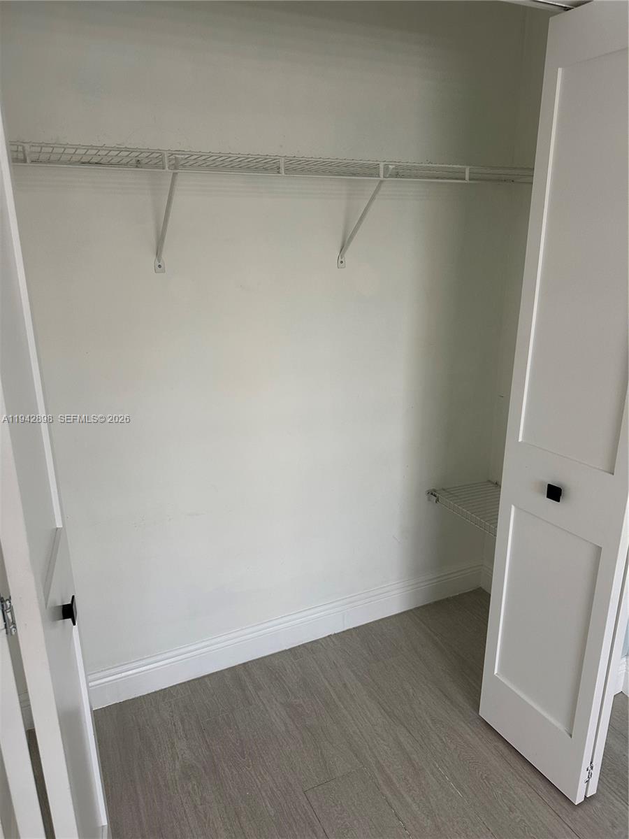 15250 Southwest 134th Place, Unit 112 Miami, FL 33177 - Photo 7 of 17 a view of a room with wooden floor and closet
