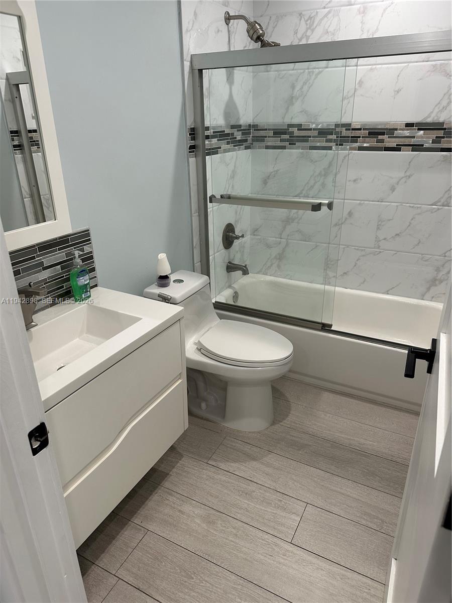 15250 Southwest 134th Place, Unit 112 Miami, FL 33177 - Photo 10 of 17 a bathroom with a sink a toilet and shower