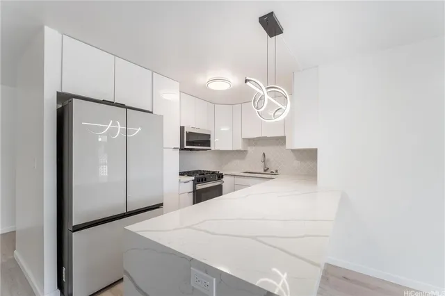 a kitchen with a refrigerator a sink and cabinets