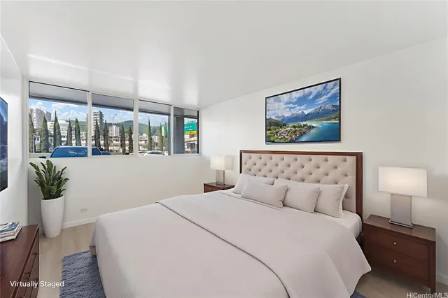 a bedroom with a large bed and a lamp