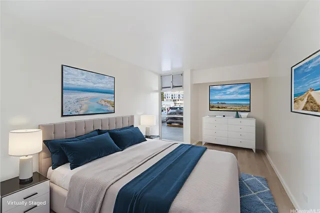 a bedroom with a bed and a view of kitchen