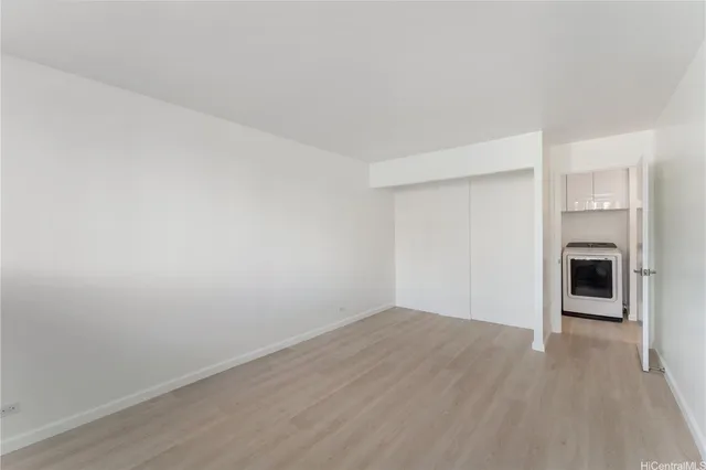 a view of a room with wooden floor and fireplace