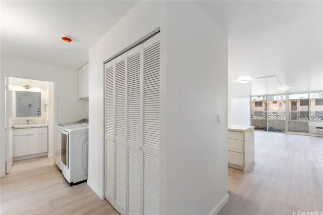 a view of a kitchen with refrigerator and wooden floor