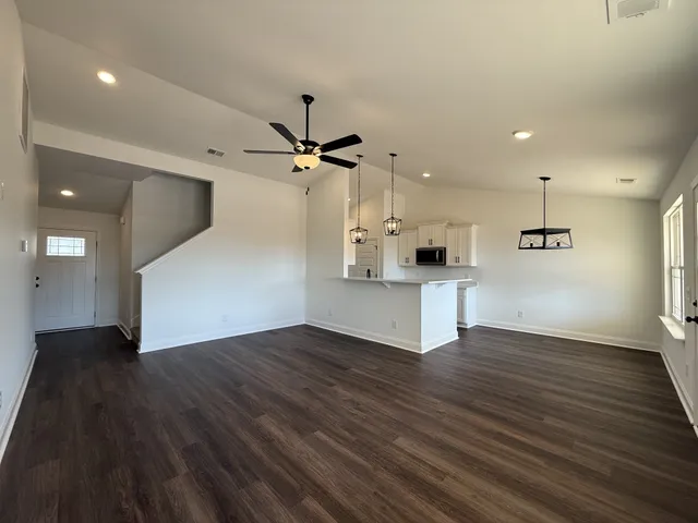 a view of a kitchen with wooden floor and a sink