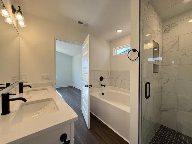 a bathroom with a sink a mirror and a bathtub