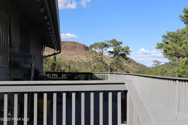 a view of a balcony with wooden fence