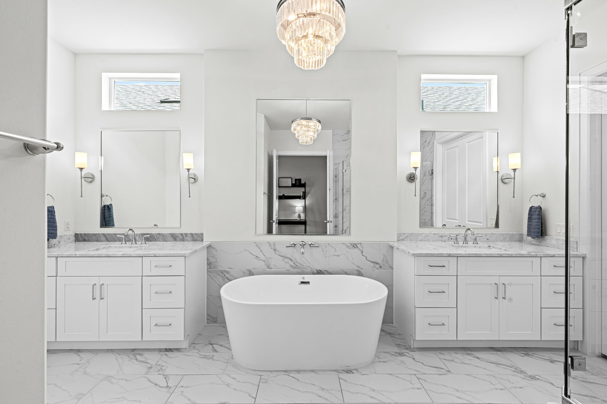 533 West 27th Street Houston, TX 77008 - Photo 13 of 22 Spa-inspired primary bath features dual vanities, Carrara marble countertops, freestanding soaking tub, oversized glass shower, and designer lighting.
