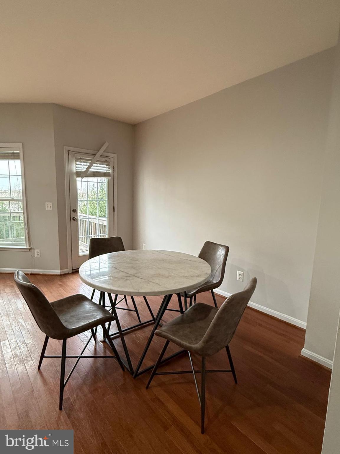 22573 Highcroft Terrace Brambleton, VA 20148 - Photo 3 of 13 a view of a dining room with furniture and wooden floor