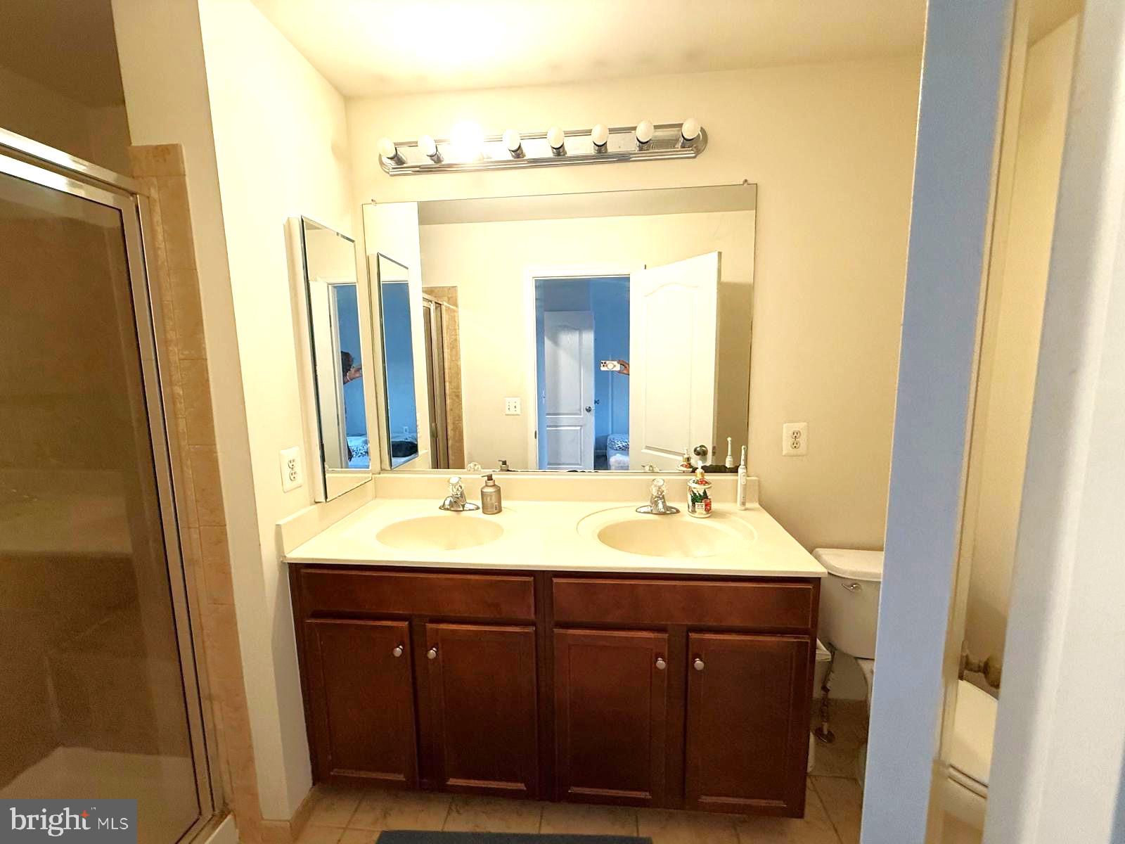 22573 Highcroft Terrace Brambleton, VA 20148 - Photo 6 of 13 a bathroom with a double vanity sink and a mirror
