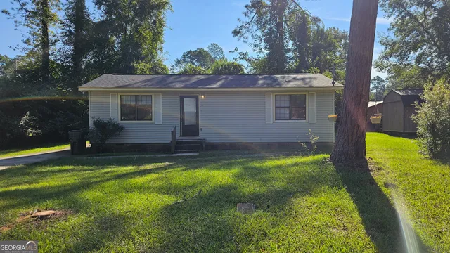 a front view of house with yard and green space