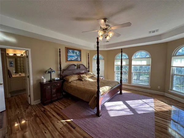 a bedroom with furniture window and wooden floor