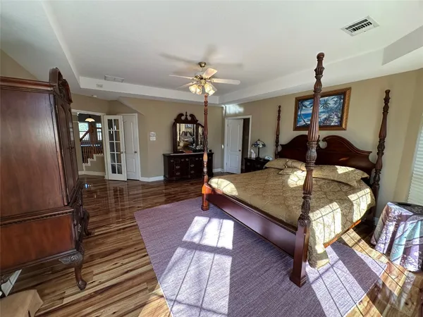 a living room with furniture a table and wooden floor