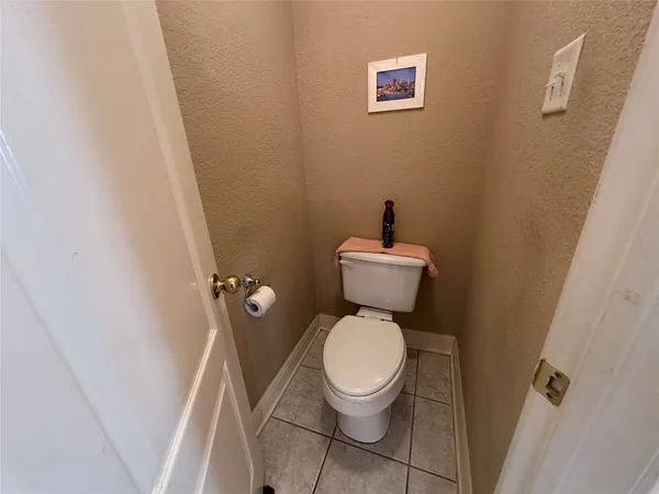 a white toilet sitting next to a small sink