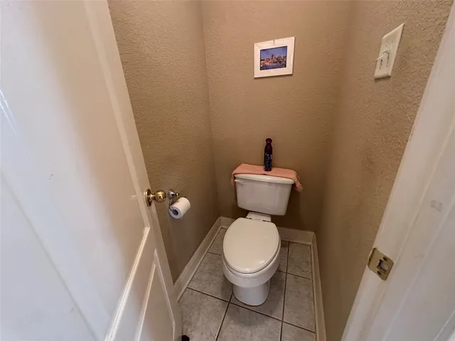 a white toilet sitting next to a small sink