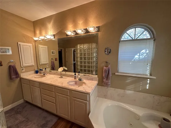 a bathroom with a double vanity sink and a mirror
