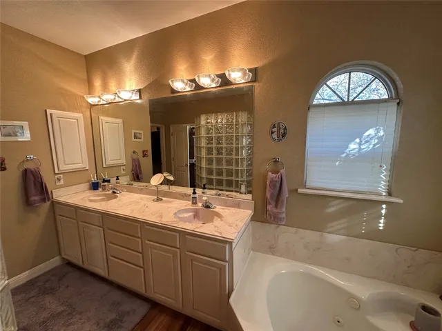 a bathroom with a double vanity sink and a mirror