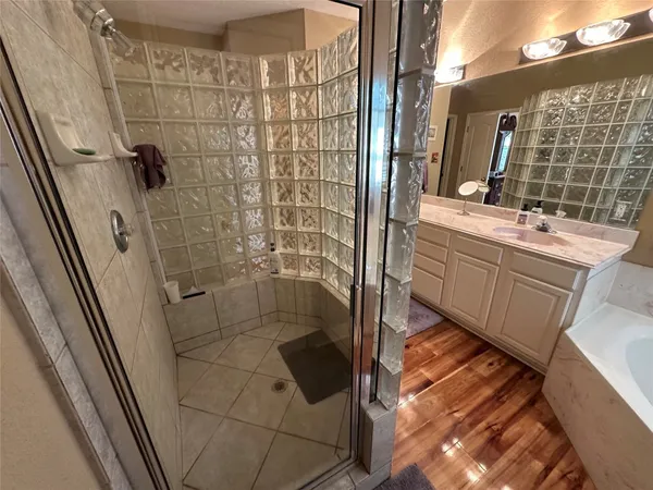 a bathroom with a shower and a sink