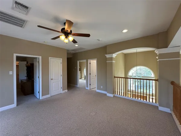 a view of a livingroom with a ceiling fan and window