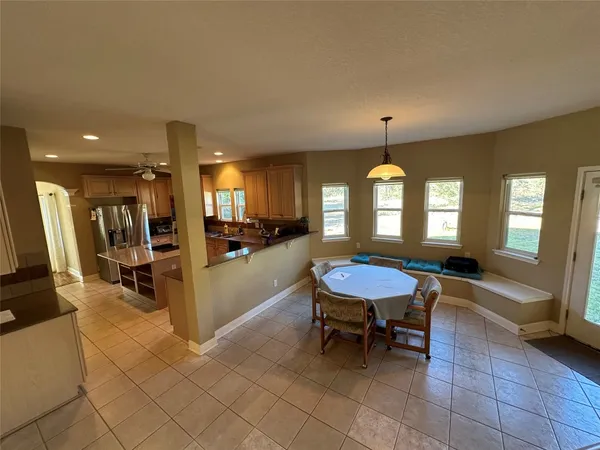 a room with furniture a air conditioner pool table and windows