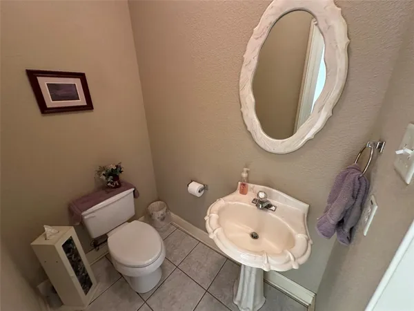 a bathroom with a toilet a sink and a mirror