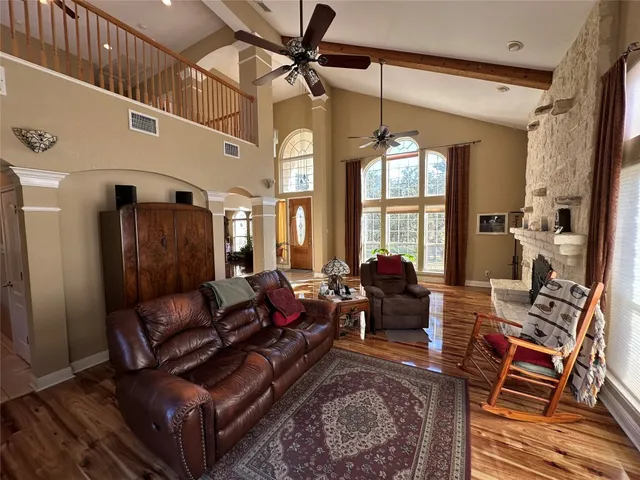 a living room with furniture ceiling fan and a rug