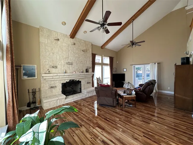 a living room with furniture wooden floor and a fireplace