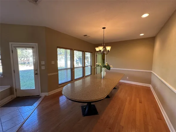 a view of a livingroom with furniture wooden floor chandelier