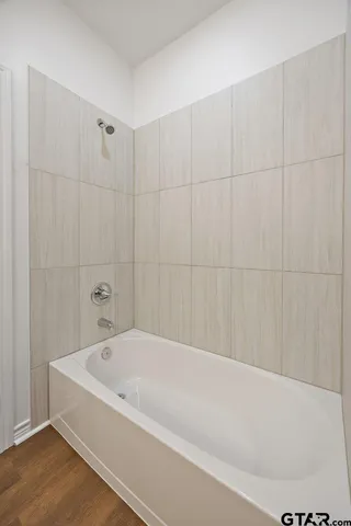 a bathroom with a sink toilet vanity and tub