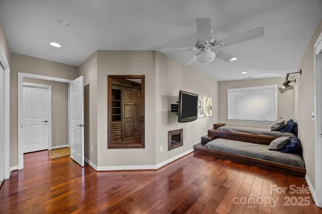 a view of a livingroom with wooden floor and a ceiling fan