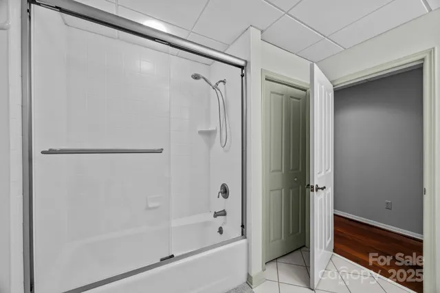 a living room with furniture tv and large windows