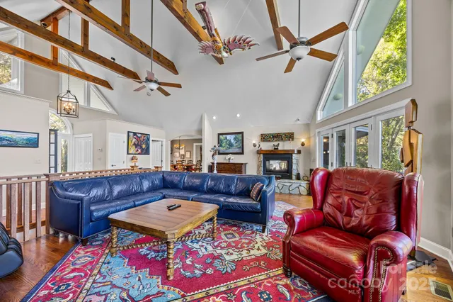 a bedroom with a bed a couch and a chandelier