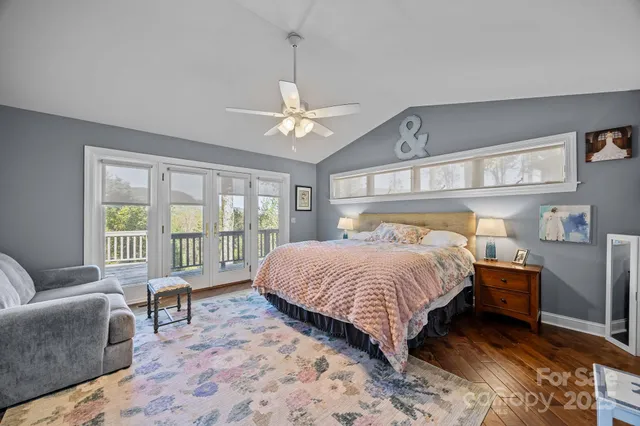 a spacious bedroom with a bed a couch and dresser