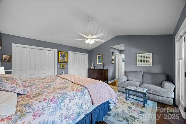 a bathroom with a granite countertop sink a large mirror and a bathtub