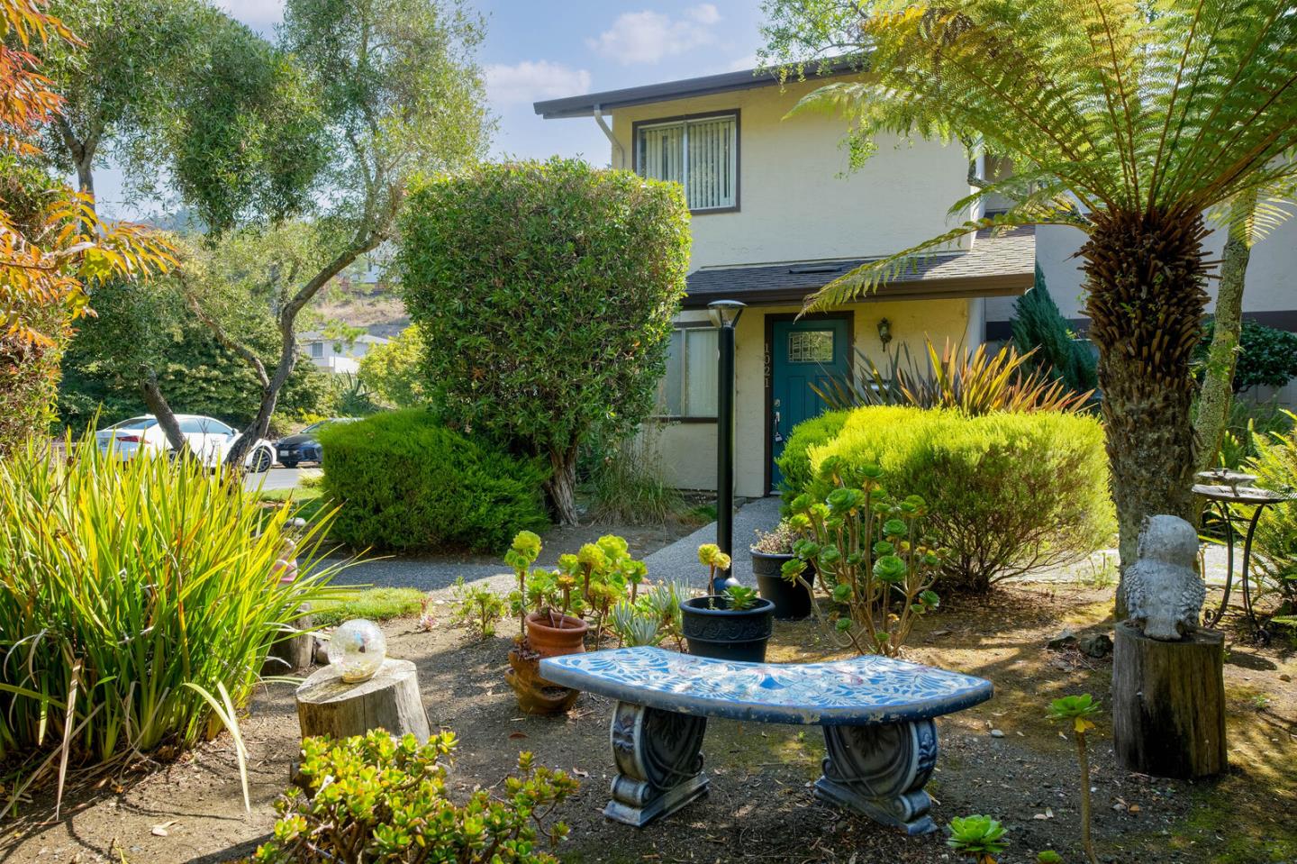 a view of a backyard with plants and a patio