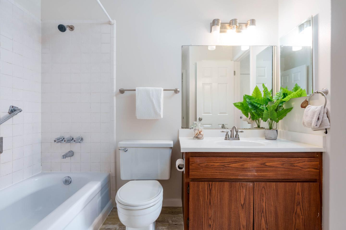 1021 Oddstad Boulevard Pacifica, CA 94044 - Photo 11 of 15 a bathroom with a sink a toilet a mirror and shower