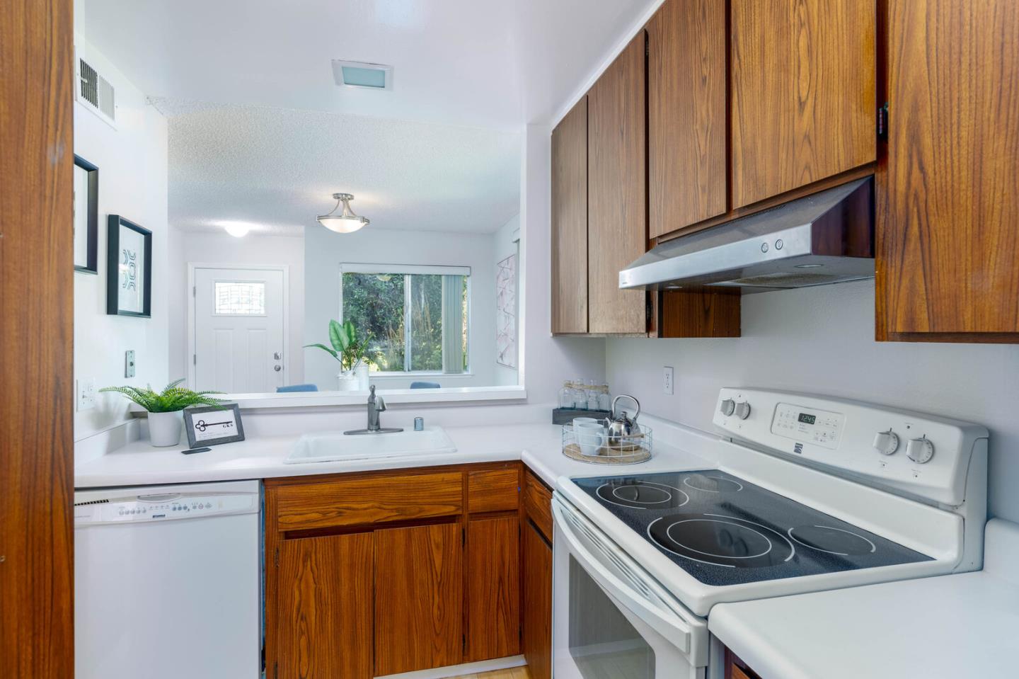 1021 Oddstad Boulevard Pacifica, CA 94044 - Photo 5 of 15 a kitchen with stainless steel appliances granite countertop a sink stove and cabinets