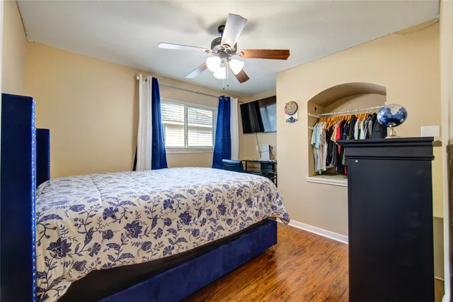 a bedroom with a bed and a chandelier