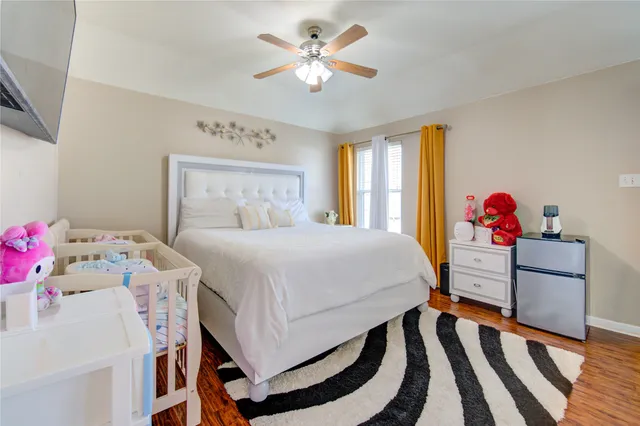a bedroom with a bed and a flat screen tv