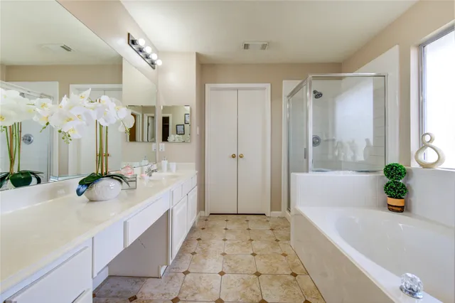a bathroom with a sink double vanity and a mirror